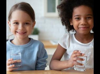 Two kids with glasses of drinking water tested with at-home testing kits from Element 
